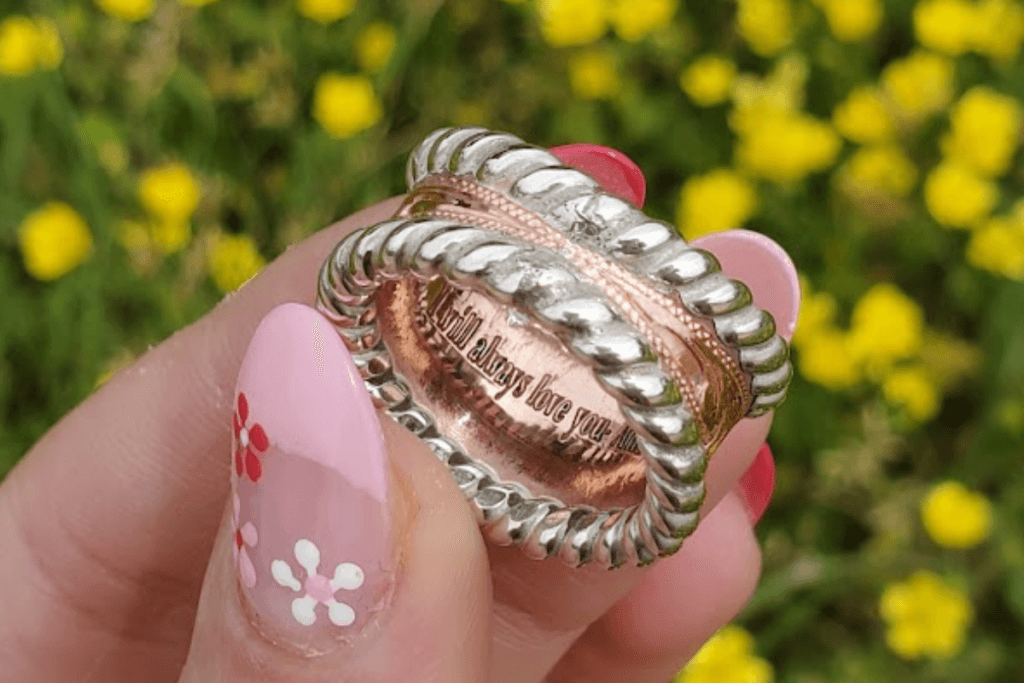 A pretty copper engraved engagement ring that says "I will always love you" inside.