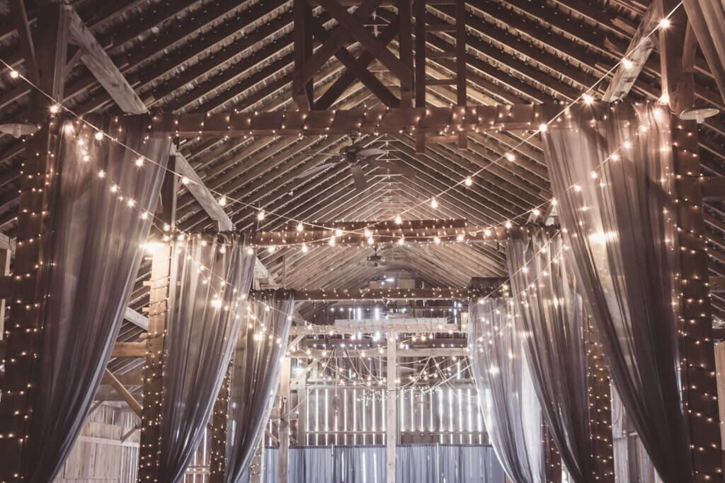 A decorated barn is shown, the perfect place for a romantic engagement. 